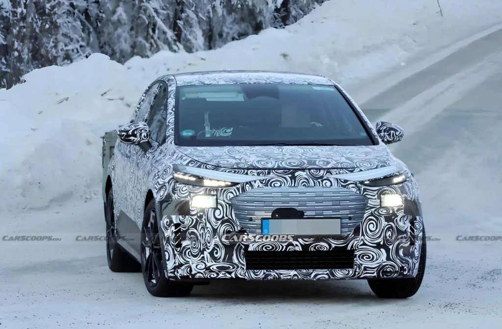 Замаскований прототип електромобіля Audi на зимових тестах у снігу, вигляд спереду