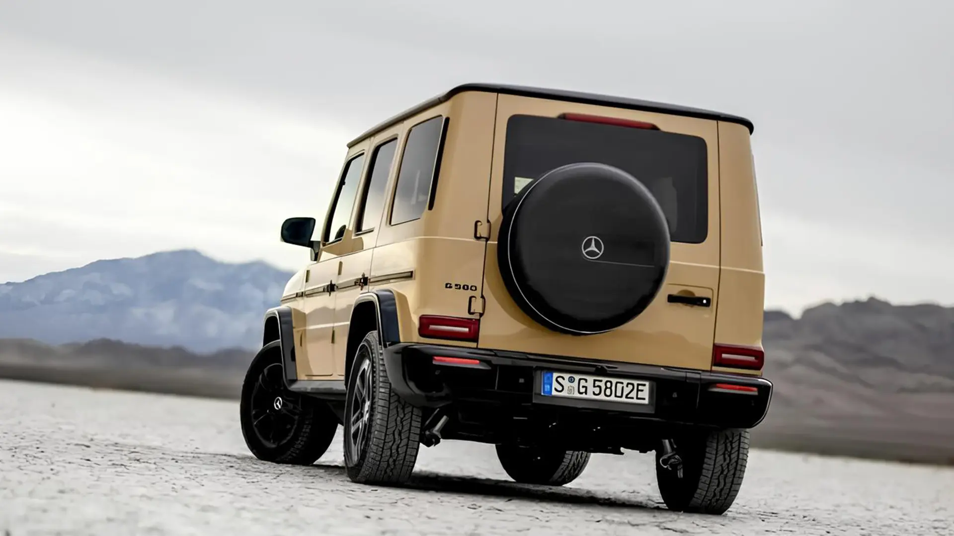 Mercedes G-Class EQ бежевого кольору, вид ззаду збоку на відкритій рівнині