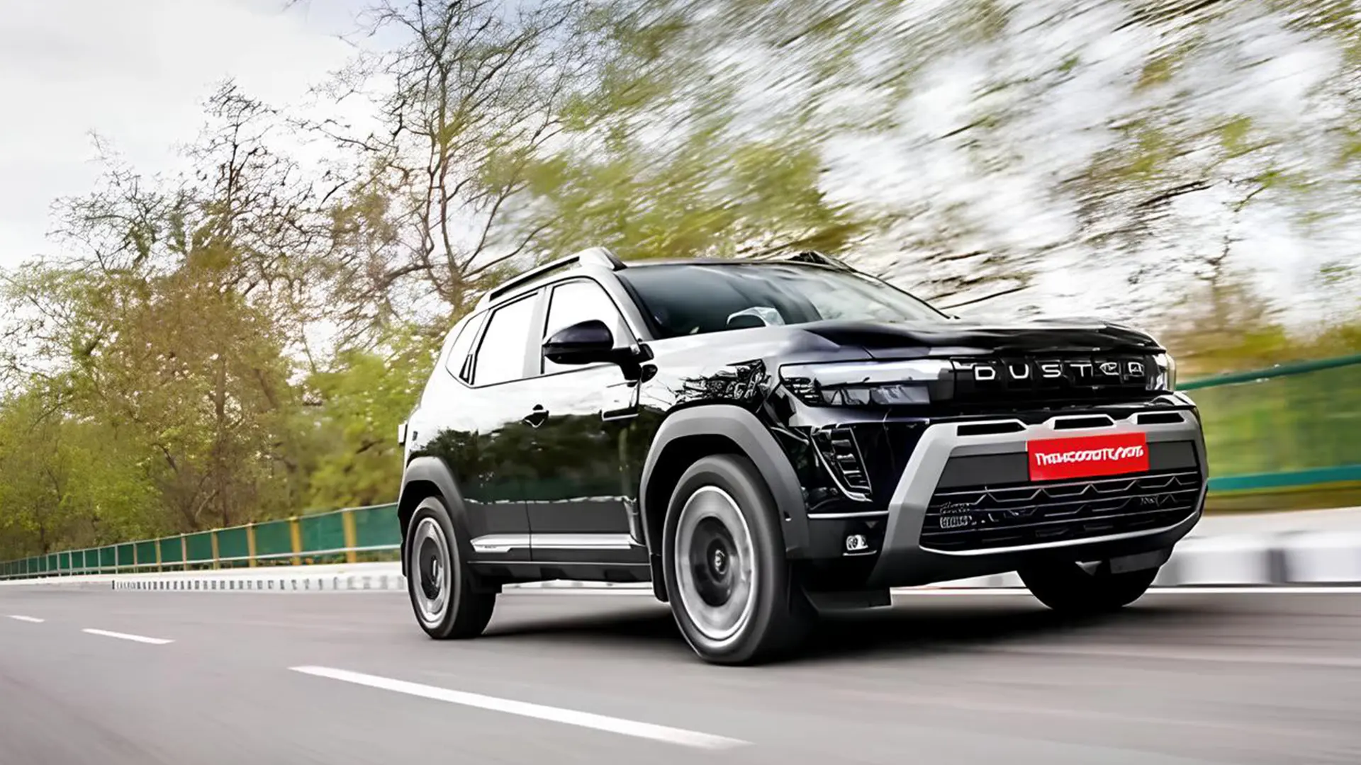 Renault Duster 2026 чорного кольору в русі на дорозі, вид спереду збоку