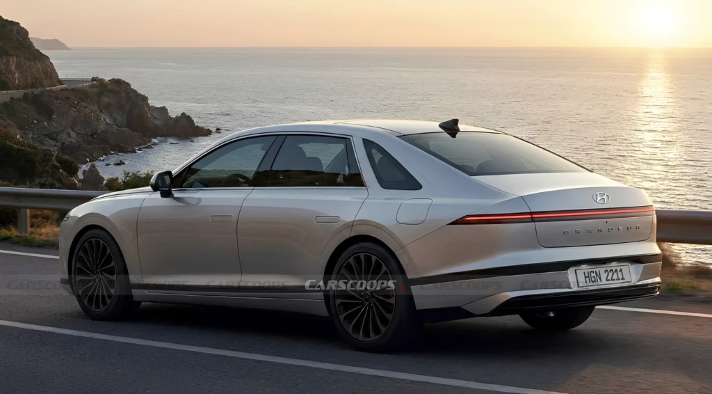 Серебристый Hyundai Grandeur едет по прибрежной дороге на закате; вид сзади сбоку, цельная LED-полоса фонарей и море на фоне