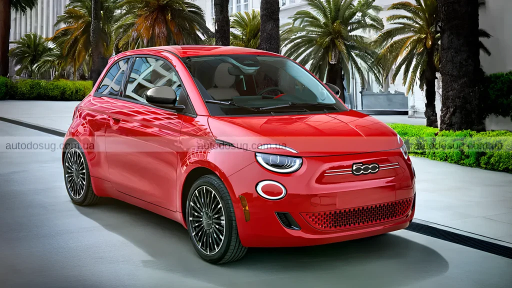 Червоний Fiat 500e 2026 припаркований біля будівлі з пальмами
