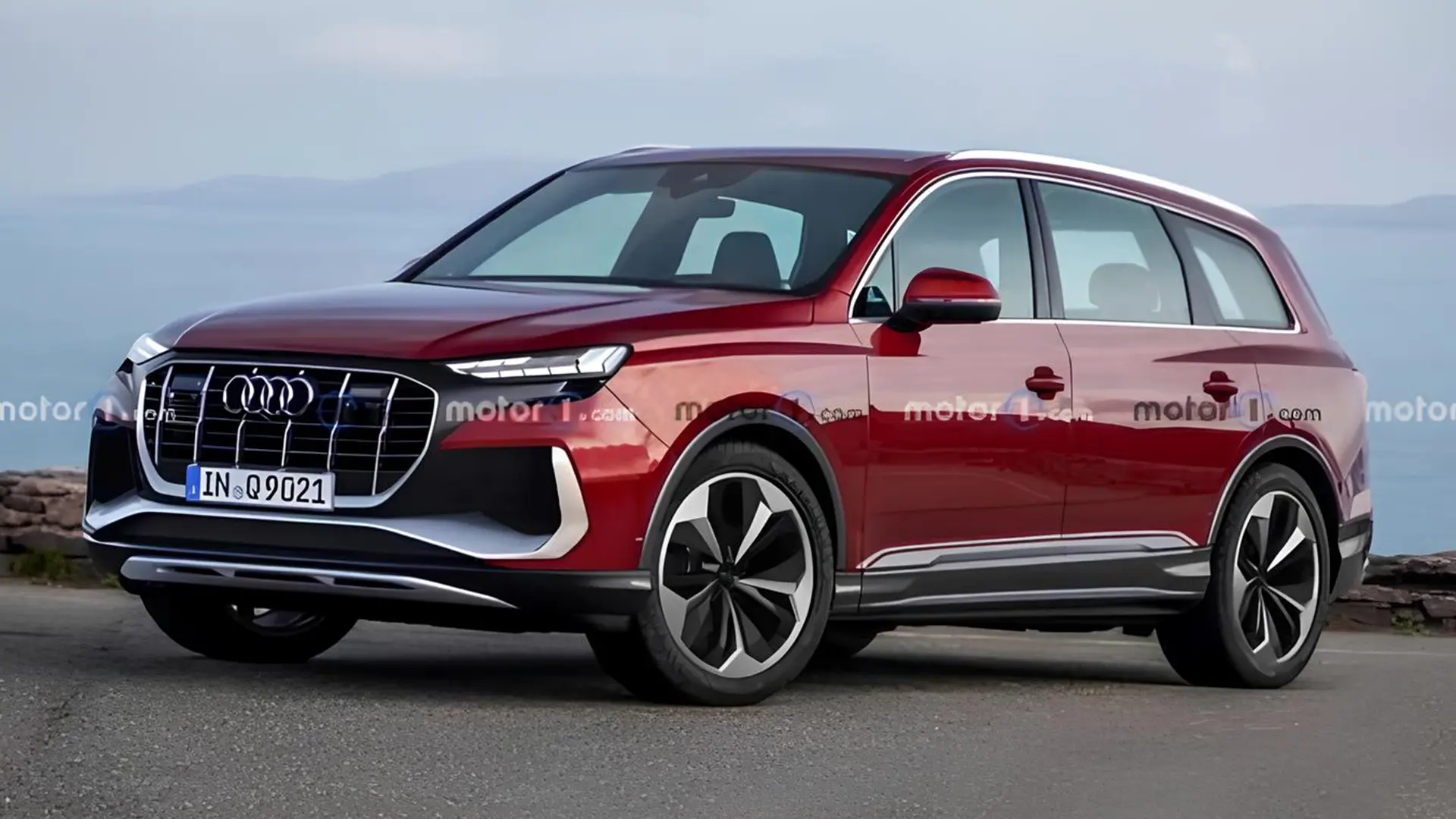 Audi Q9 червоного кольору, вид спереду збоку на тлі узбережжя