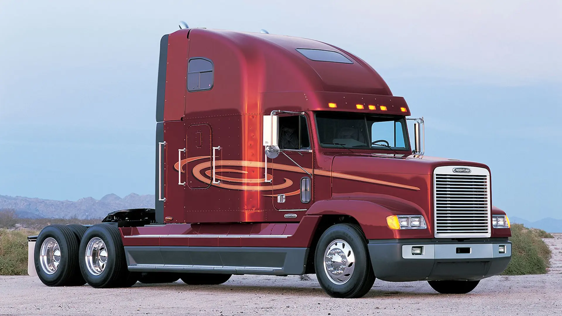 Вантажний тягач із високою кабіною на стоянці, вигляд спереду збоку