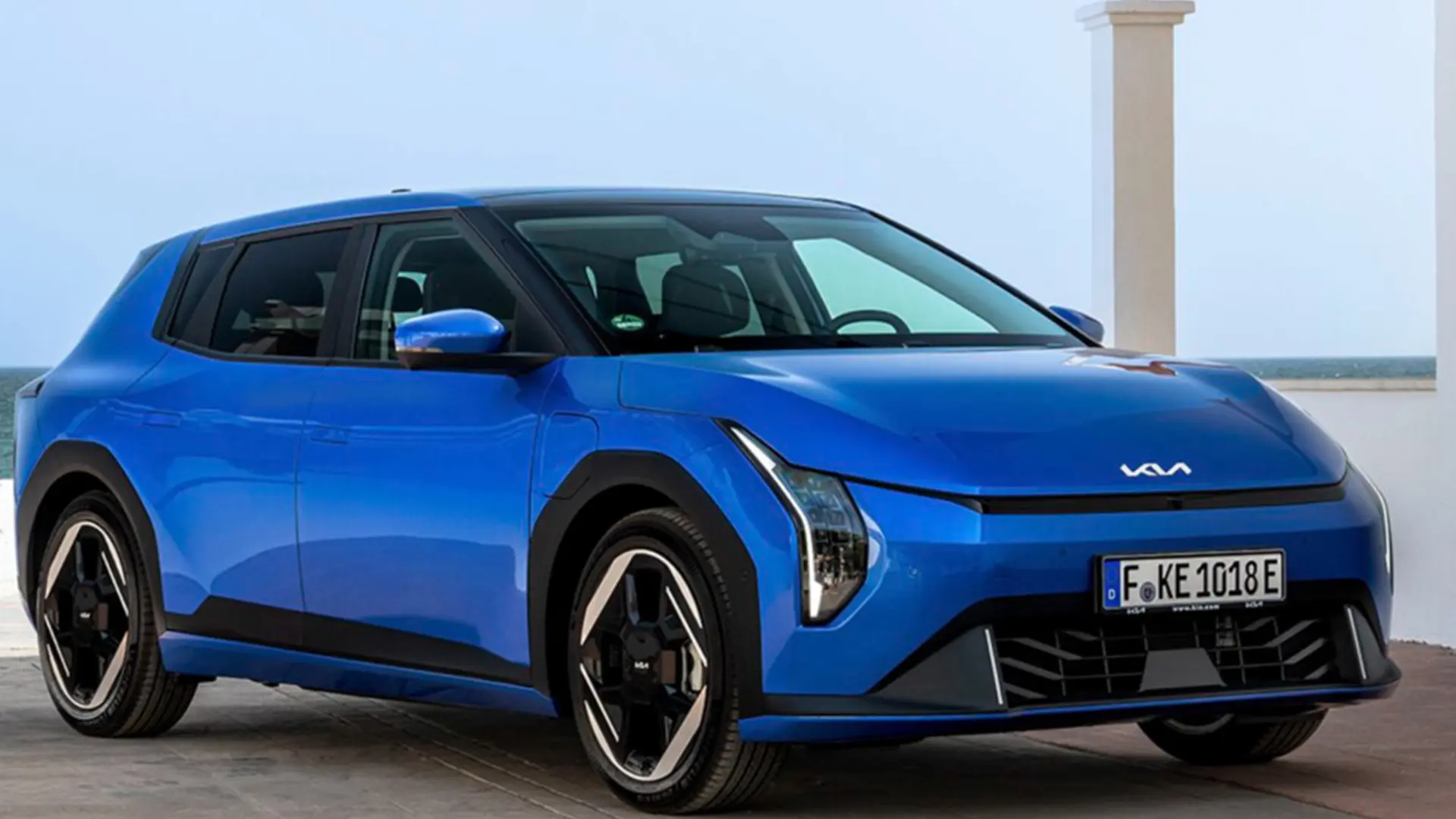 Синій електромобіль KIA EV4 на відкритому майданчику біля моря