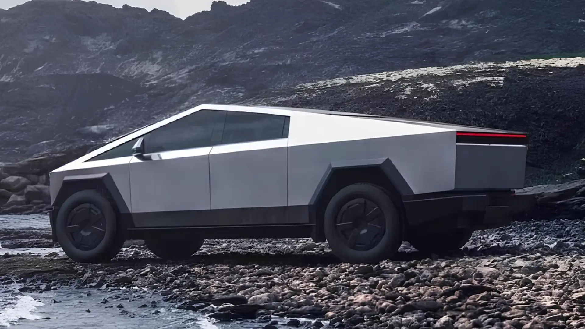 Tesla Cybertruck на кам’янистій місцевості на тлі гір