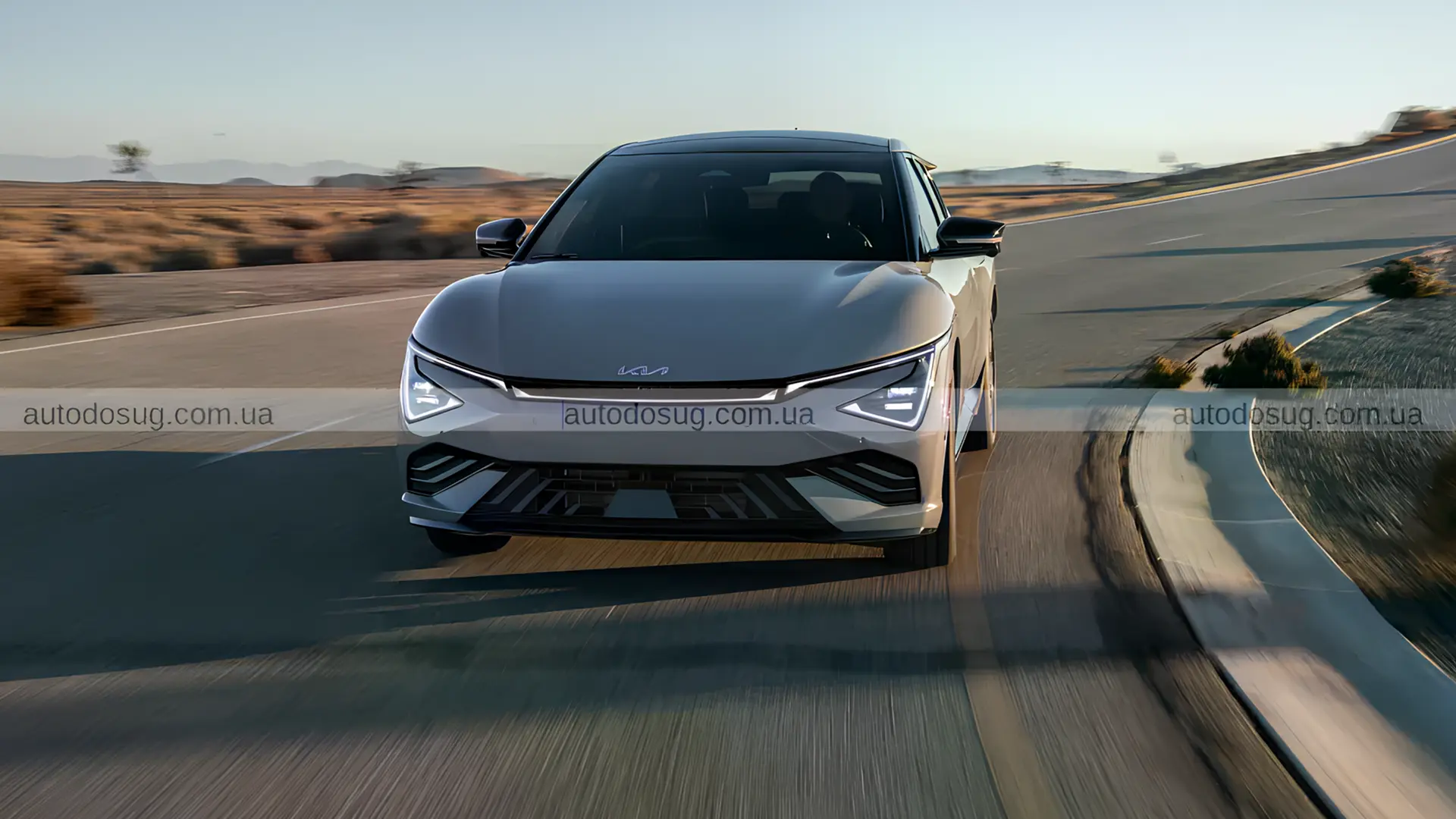 Білий Kia EV6 2026 року в русі на дорозі в відкритому ландшафті