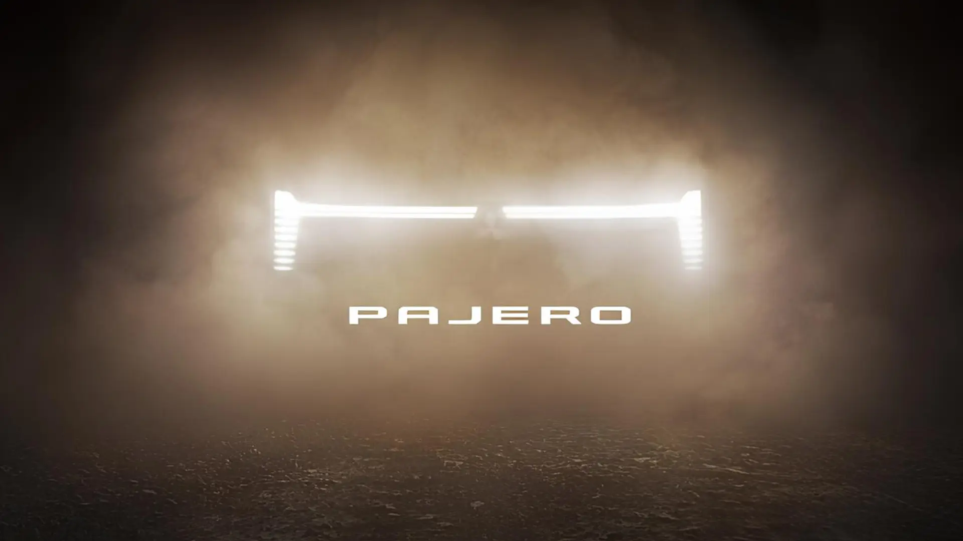 Тизер Mitsubishi Pajero з підсвіченим силуетом позашляховика в пилу